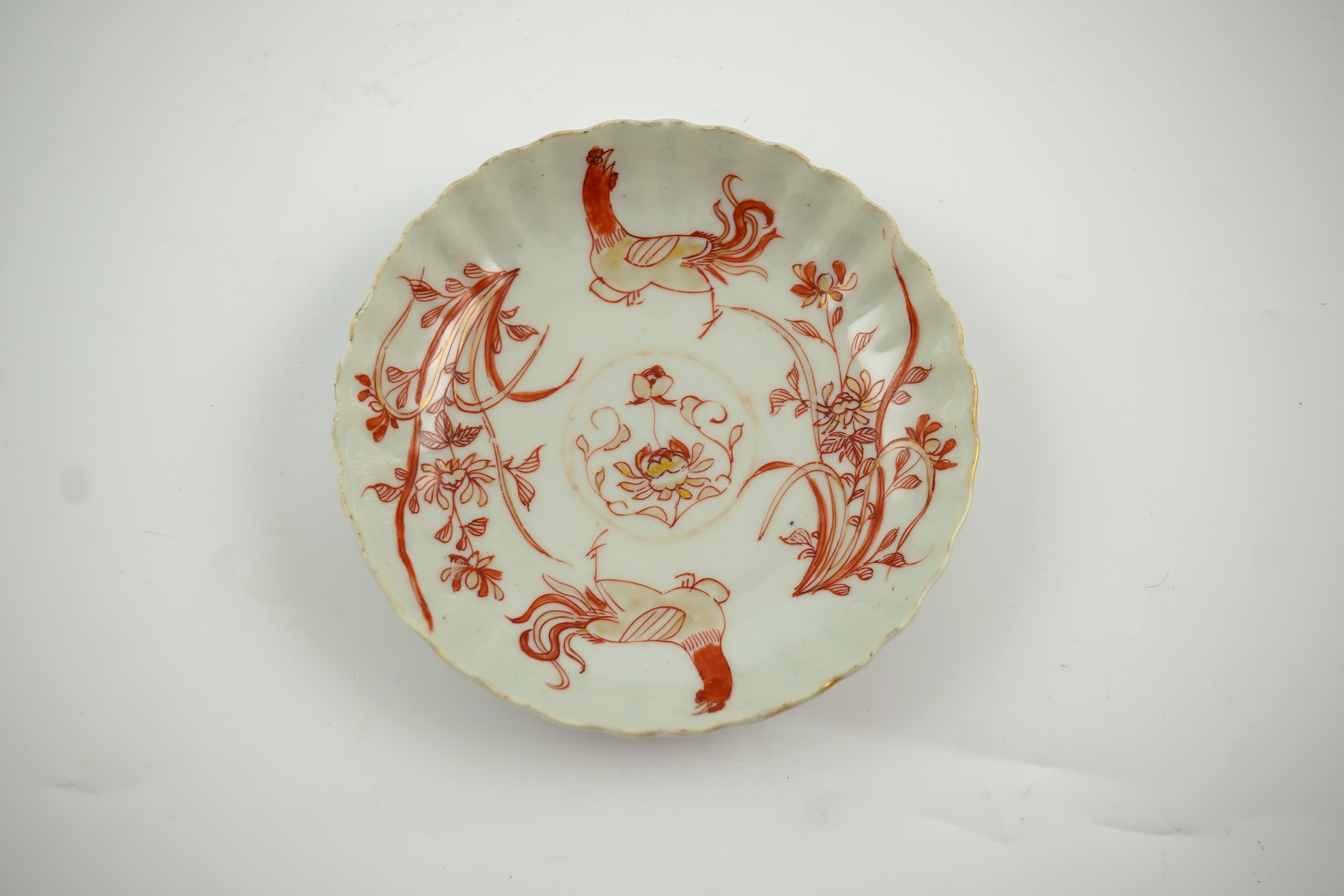 A Chinese rouge de fer tea bowl and saucer and a similar cup, Qianlong period